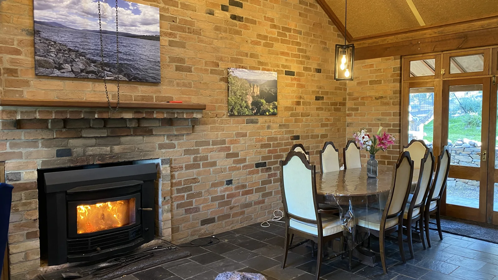 Dining table beside the brick fireplace